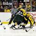 Michigan junior right wingman Derek DeBlois watches the puck as he is tied up with a Michigan State player at Joe Louis Arena on Saturday, Feb. 2. Daniel Brenner I AnnArbor.com